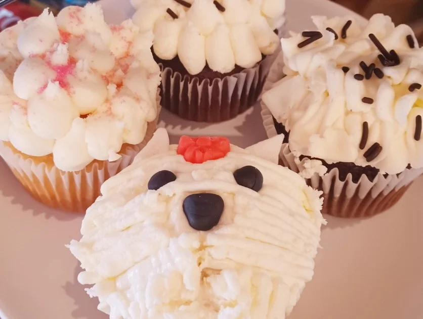 Whimsical cupcakes, one designed as a yorkie