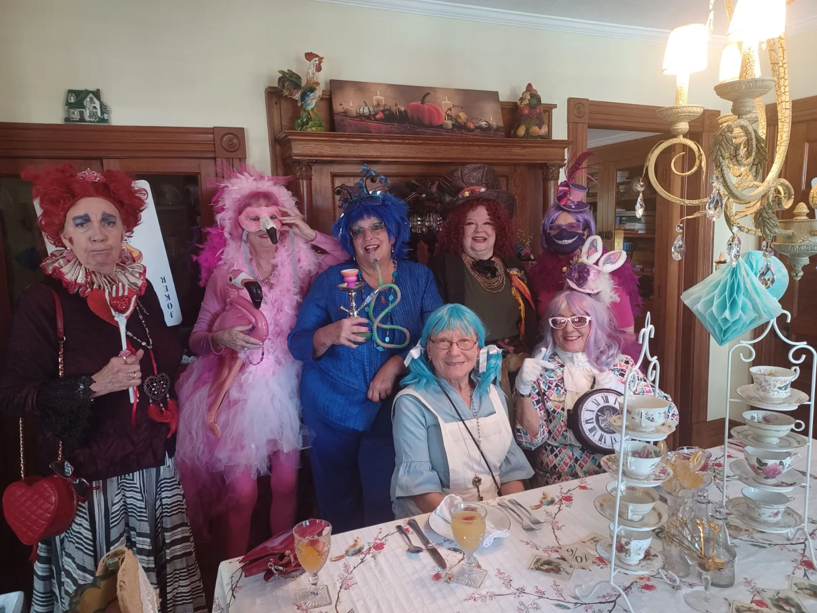 Image of Ladies dressed in Alice in Wonderland Costumes Having Tea